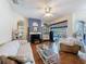 Bright living room with a fireplace, wood floors, and an open layout perfect for entertaining at 1052 Archway Dr, Spring Hill, FL 34608
