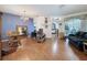 Spacious living room with wood floors, vaulted ceiling, and ample natural light from sliding glass doors at 1052 Archway Dr, Spring Hill, FL 34608