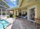 Covered brick paver patio with ceiling fans and access to pool at 1052 Archway Dr, Spring Hill, FL 34608