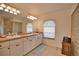 Spacious bathroom features double sinks, decorative lighting, and a glass block shower at 536 Boundary Blvd, Rotonda West, FL 33947