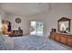 Cozy bedroom with neutral walls, an office setup, and a sliding glass door to the pool area at 536 Boundary Blvd, Rotonda West, FL 33947