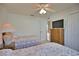 Comfortable bedroom featuring twin beds, ceiling fan, and a wicker TV stand at 536 Boundary Blvd, Rotonda West, FL 33947