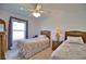 Cozy bedroom with two twin beds, ceiling fan, and a window with natural light at 536 Boundary Blvd, Rotonda West, FL 33947