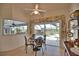 Cozy breakfast nook with views of the pool area, featuring a ceiling fan and natural light at 536 Boundary Blvd, Rotonda West, FL 33947