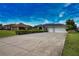Long driveway leading up to an attractive single Gathering home with lush landscaping at 536 Boundary Blvd, Rotonda West, FL 33947