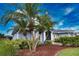 This exterior home showcases a lush tropical landscaping with palm trees and well-manicured bushes, offering a serene view at 536 Boundary Blvd, Rotonda West, FL 33947