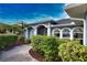 Charming home exterior featuring a landscaped yard, arched entryway, and a driveway leading to the entrance at 536 Boundary Blvd, Rotonda West, FL 33947