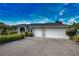 Charming single-story home with an attached three-car garage, lush landscaping, and a well-maintained lawn at 536 Boundary Blvd, Rotonda West, FL 33947