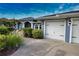 Charming home exterior showcases lush landscaping and a three-car garage at 536 Boundary Blvd, Rotonda West, FL 33947