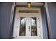 Elegant double front doors with decorative glass and transom window at 536 Boundary Blvd, Rotonda West, FL 33947