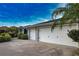 Attached three-car garage with well-maintained landscaping and driveway at 536 Boundary Blvd, Rotonda West, FL 33947
