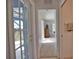 Hallway view leads to bedroom featuring a shuttered window and wicker dresser at 536 Boundary Blvd, Rotonda West, FL 33947