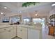 Bright kitchen with countertops, white appliances, a double sink, and views of the outdoor dining and pool area at 536 Boundary Blvd, Rotonda West, FL 33947