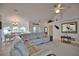 Spacious living room with vaulted ceiling, fan, and a view of the dining area and front door at 536 Boundary Blvd, Rotonda West, FL 33947