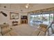Well-lit living area with view of screened-in pool, comfortable seating, and tiled flooring at 536 Boundary Blvd, Rotonda West, FL 33947