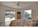 Bedroom with sliding glass doors to outdoor pool area and a window with shutters at 536 Boundary Blvd, Rotonda West, FL 33947
