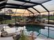 Screened lanai with luxurious pool with rock waterfall feature and tropical landscaping at 536 Boundary Blvd, Rotonda West, FL 33947