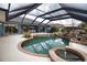 Screened in pool area featuring a water feature and jacuzzi spa offering a relaxing outdoor retreat at 536 Boundary Blvd, Rotonda West, FL 33947