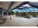 Screened-in lanai with a unique custom pool with waterfall feature at 536 Boundary Blvd, Rotonda West, FL 33947