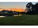 Beautiful canal view at sunset, featuring verdant lawns extending to the water's edge, reflecting a serene atmosphere at 536 Boundary Blvd, Rotonda West, FL 33947