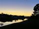 Picturesque sunset view over the canal, showcasing the tranquil waterfront setting of the property at 536 Boundary Blvd, Rotonda West, FL 33947