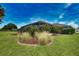 Well-manicured lawn with lush landscaping surrounds the property, enhancing its curb appeal at 536 Boundary Blvd, Rotonda West, FL 33947