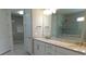 Elegant bathroom features double sinks with granite countertops and a glass-enclosed shower at 13639 Salinas St, Venice, FL 34293