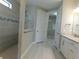 Contemporary bathroom boasts a sleek glass shower enclosure, double sinks, and a large vanity at 13639 Salinas St, Venice, FL 34293