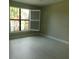 Bedroom with light tile flooring with a window that fills the room with natural light at 13639 Salinas St, Venice, FL 34293