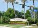 Islandwalk at the West Villages community entrance with lush landscaping and an American flag at 13639 Salinas St, Venice, FL 34293