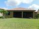 Spacious screened lanai with a lovely red tile roof and manicured lawn at 13639 Salinas St, Venice, FL 34293