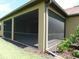 A spacious screened lanai with a neutral earth toned brick floor at 13639 Salinas St, Venice, FL 34293