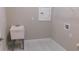 Functional laundry room features a utility sink, storage, and connections for a washer and dryer at 13639 Salinas St, Venice, FL 34293