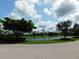 Community view showing water feature with lush trees and vegetation at 13639 Salinas St, Venice, FL 34293