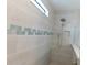 Modern shower features attractive tiling and a shower head at 13639 Salinas St, Venice, FL 34293