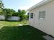 This is a view of the side and backyard, enclosed by a white fence offering privacy at 21970 Cellini Ave, Port Charlotte, FL 33952