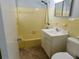 Well-lit bathroom featuring a vanity, toilet, and shower-tub combination at 21970 Cellini Ave, Port Charlotte, FL 33952