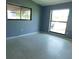 This bedroom offers two large windows that allow natural light in to illuminate the terrazzo floors at 21970 Cellini Ave, Port Charlotte, FL 33952