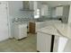 Bright kitchen with white cabinets, stylish backsplash, stone countertops, and ample counter space at 21970 Cellini Ave, Port Charlotte, FL 33952