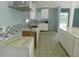 Bright kitchen with white cabinets, stylish backsplash, stone countertops, and ample counter space at 21970 Cellini Ave, Port Charlotte, FL 33952