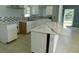 Bright kitchen with white cabinets, stylish backsplash, stone countertops, and ample counter space at 21970 Cellini Ave, Port Charlotte, FL 33952
