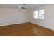 Spacious bedroom with wood-look flooring, ceiling fan and abundant natural light at 3536 Harbor Blvd, Port Charlotte, FL 33952