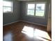 Cozy bedroom featuring natural light and wood-look floors at 3536 Harbor Blvd, Port Charlotte, FL 33952