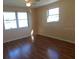 Spacious bedroom with windows offering great natural light and featuring wood flooring at 3536 Harbor Blvd, Port Charlotte, FL 33952