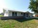Charming single-story home featuring a white tile roof, manicured lawn, and an attached garage at 3536 Harbor Blvd, Port Charlotte, FL 33952