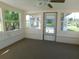 Bright sunroom featuring neutral colors, large windows, and a ceiling fan for added comfort at 3536 Harbor Blvd, Port Charlotte, FL 33952