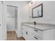 Bright bathroom featuring a granite countertop vanity, sleek black hardware, and a walk-in shower at 14 S Forest St, Plant City, FL 33563