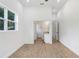 Bedroom featuring plank flooring, white walls, and an open doorway to the ensuite bathroom at 14 S Forest St, Plant City, FL 33563
