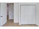 Hallway showcasing stylish wood-look flooring and convenient closet space at 14 S Forest St, Plant City, FL 33563