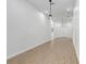 Spacious living room showcasing plank flooring, white walls, and modern light fixtures at 14 S Forest St, Plant City, FL 33563